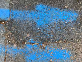 bright blue arrow spray painted markings on tarmac