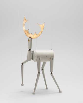 A puppet made of wood in the form of a deer